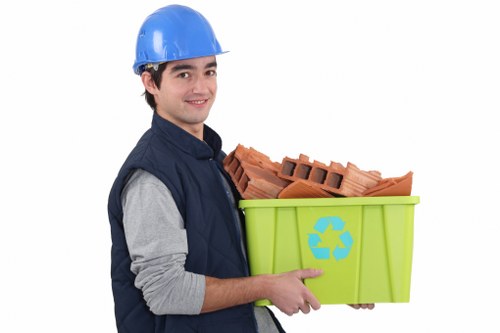 Workers sorting cardboard and recyclables at a depot